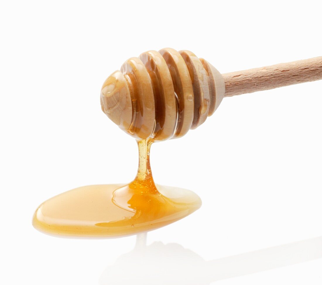 Honey dripping from a honey dipper