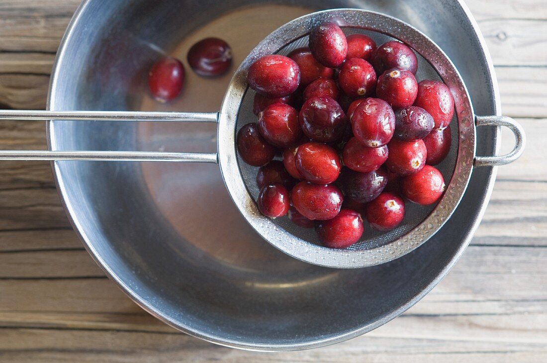 Freshly washed cranberries in a sieve