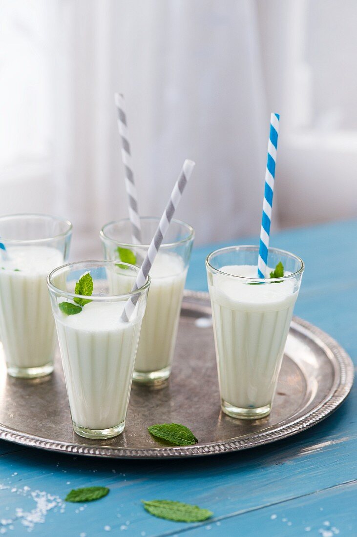 Four glasses of ayran yoghurt drink with salt and fresh mint