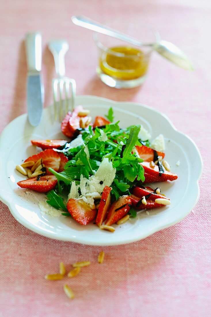 Rocket salad with strawberries, parmesan, balsamic vinegar and pine nuts