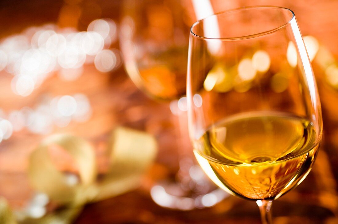 Glasses of white wine on a table laid for a celebration