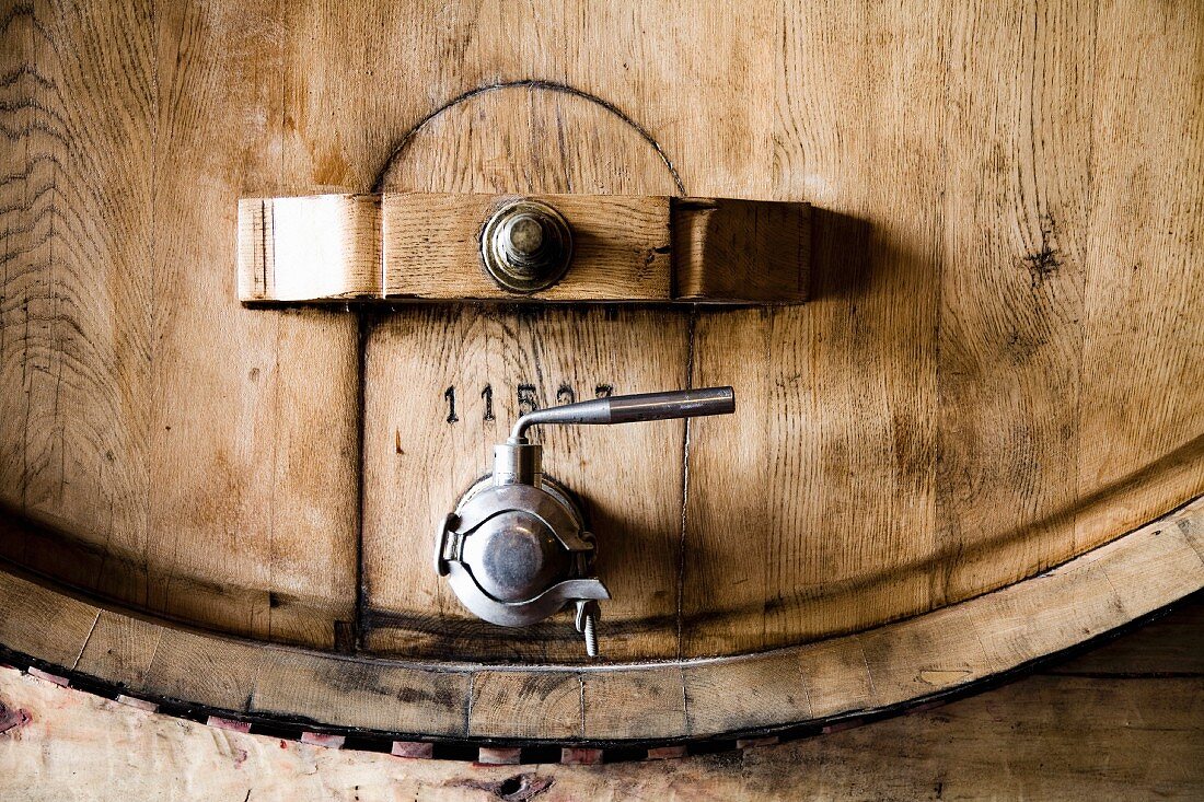 A wooden barrel with a metal tap