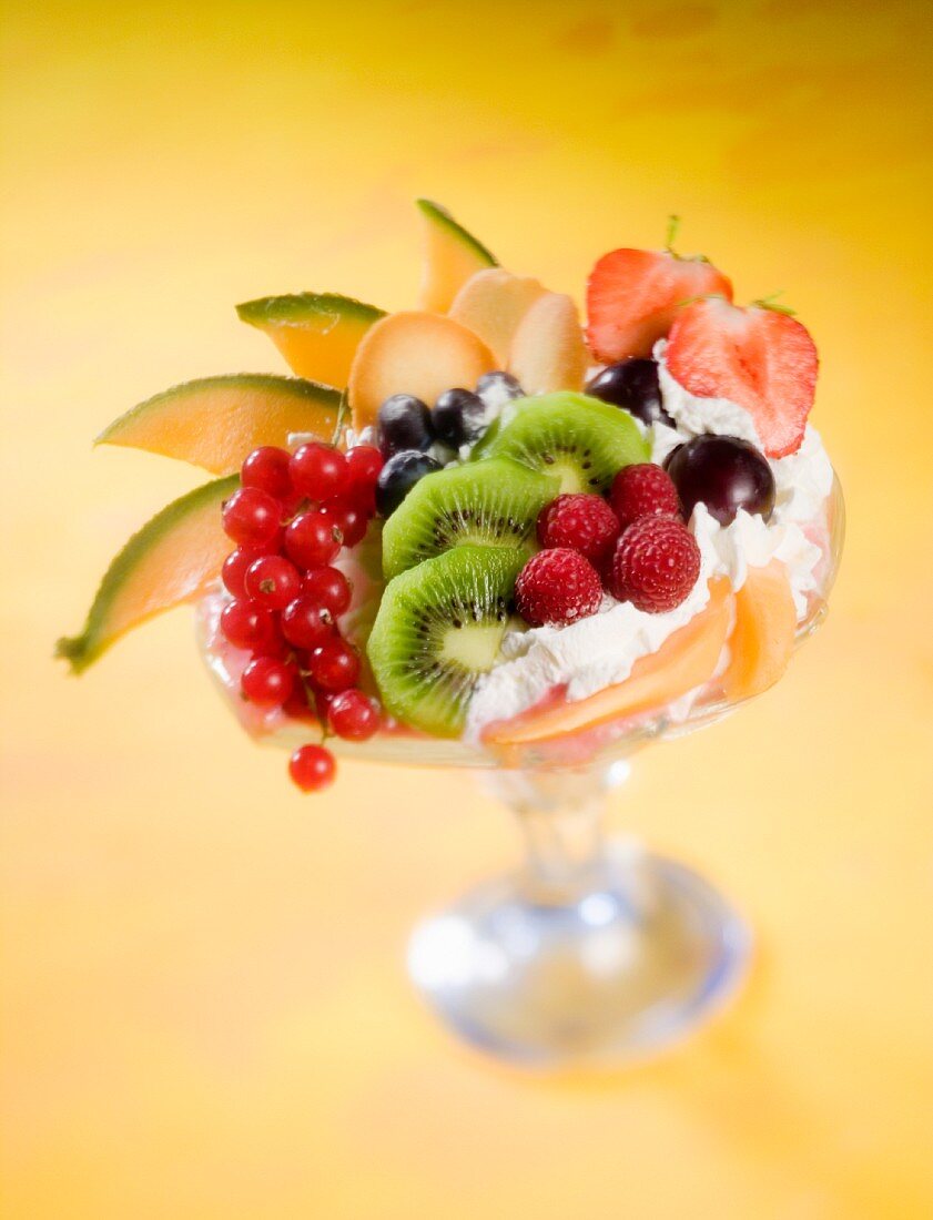 Fruit dessert with whipped cream and biscuits