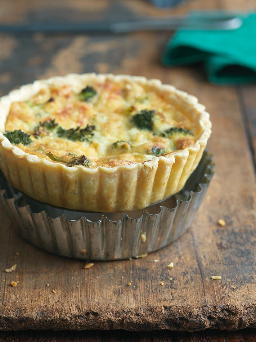 Individual Broccoli and Cheese Quiche On Top of Baking Tin