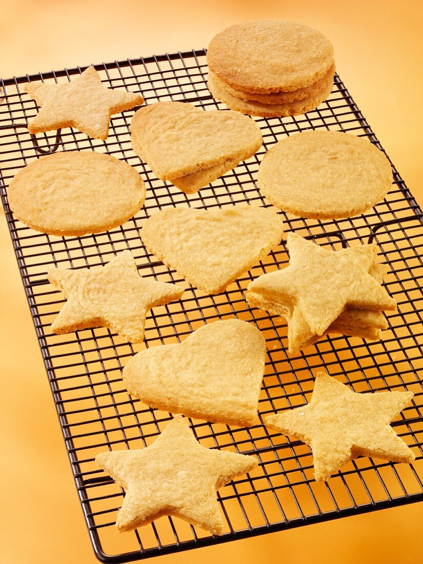 Biscuits in assorted shapes (hearts, stars, circles) on a cooling rack