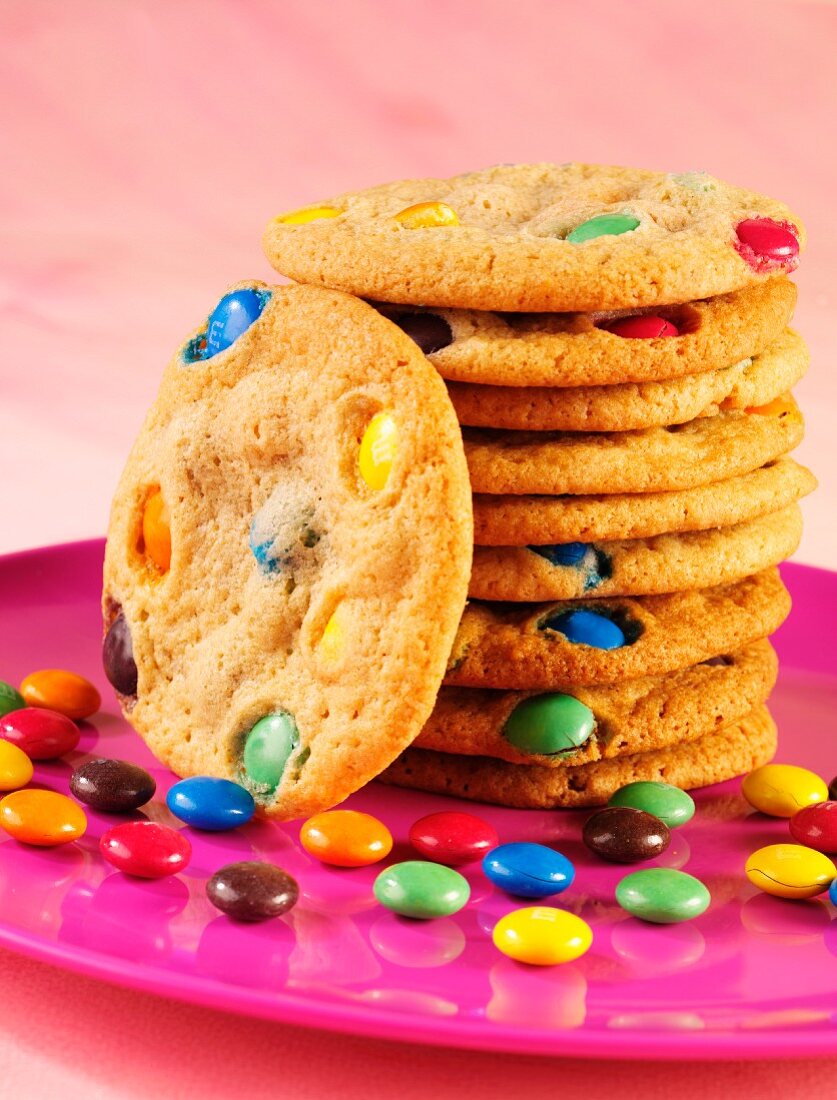 A stack of cookies with colourful chocolate beans