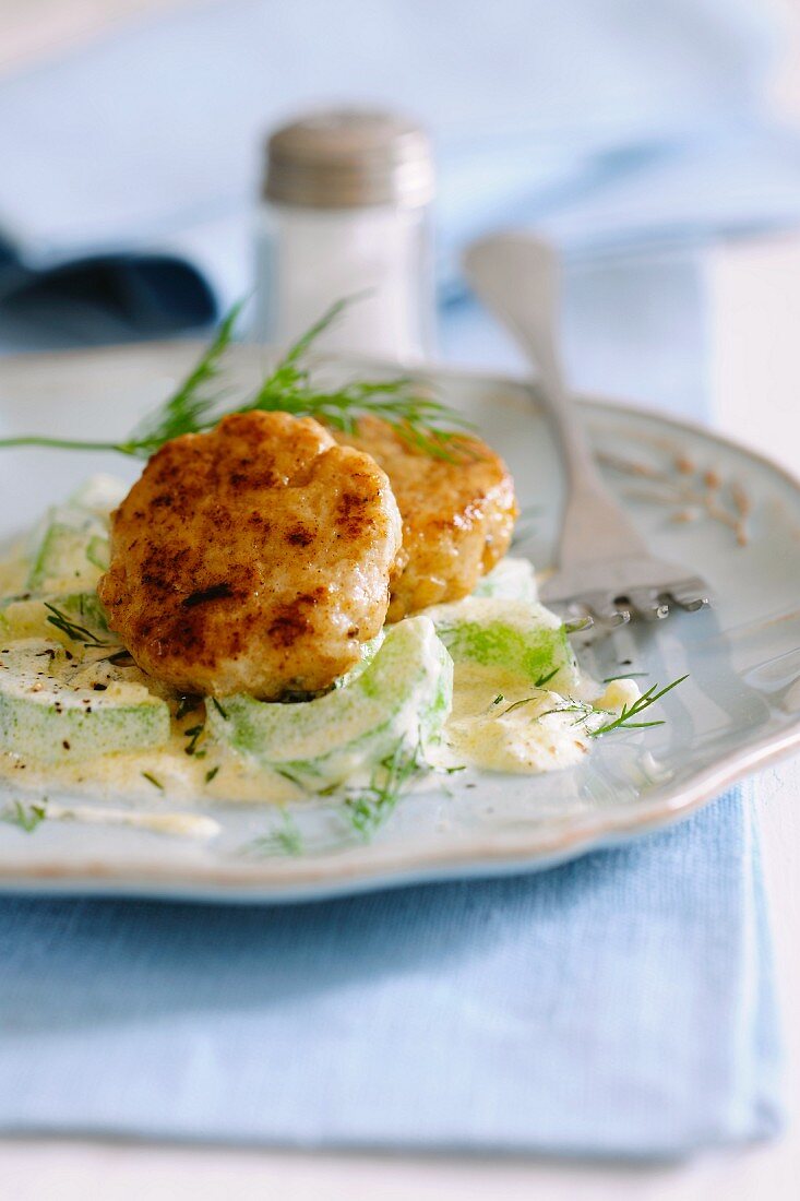 Nuggets of fish on dill and cucumbers