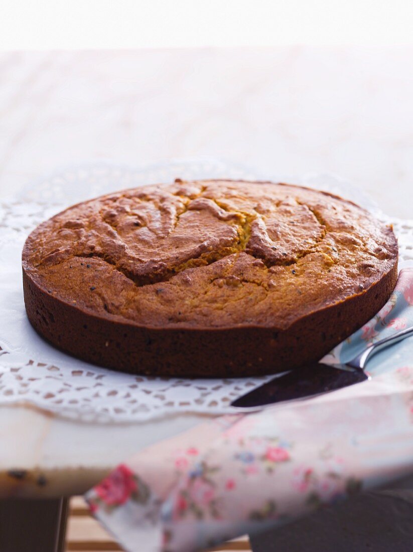 A whole almond cake on a doily