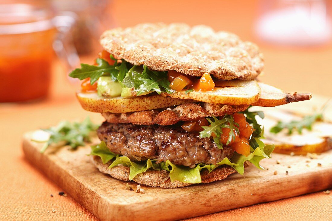 A hamburger with pears and mango chutney