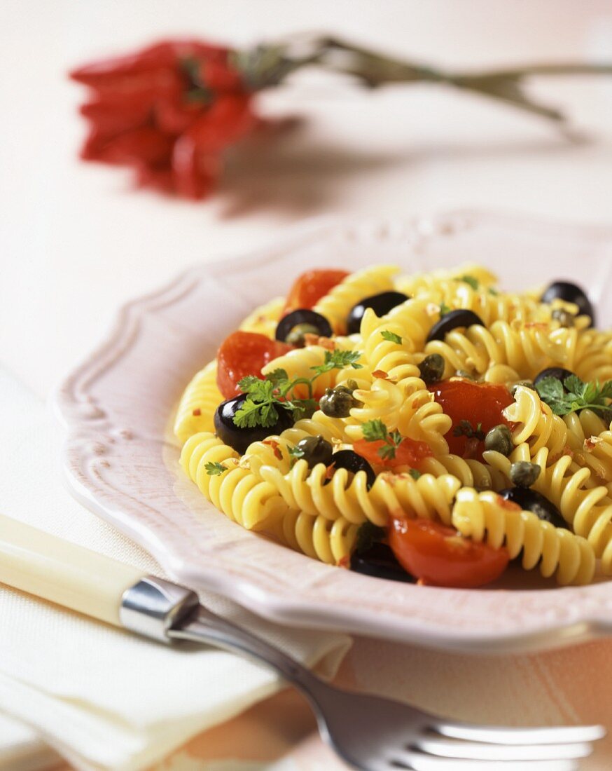 Pasta with black olives, capers, cherry tomatoes and parsley