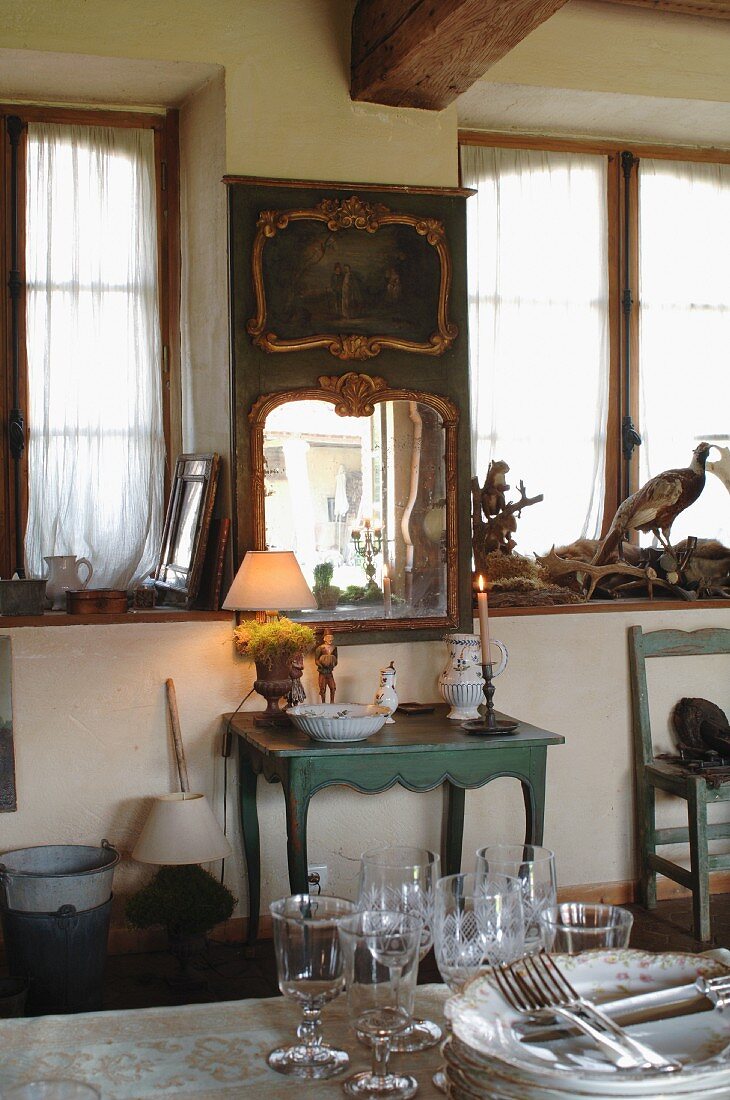 Ornaments and collection of antiques in rustic kitchen-dining room