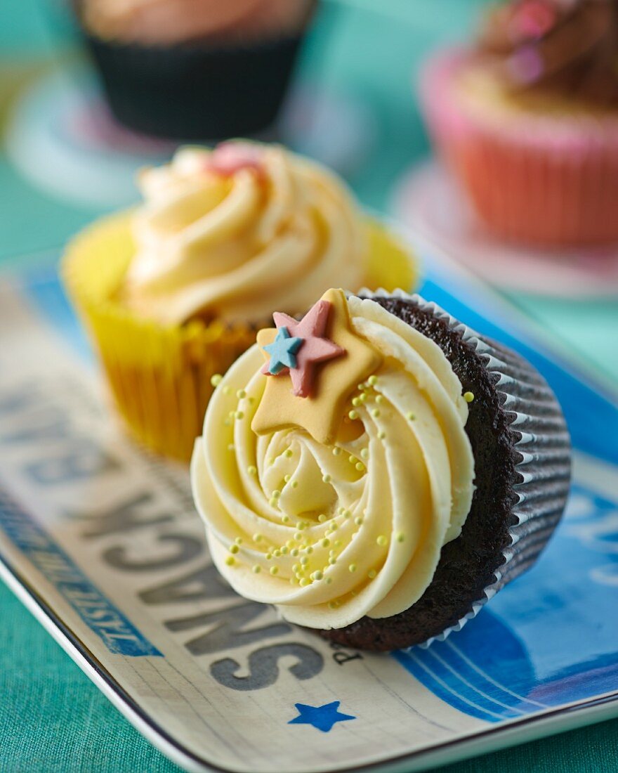 A cupcake decorated with stars, lying on its side