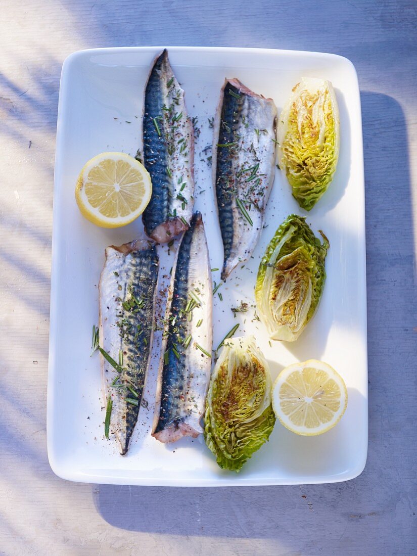 Mackerel in a mustard and onion marinade with fried lettuce hearts and lemon