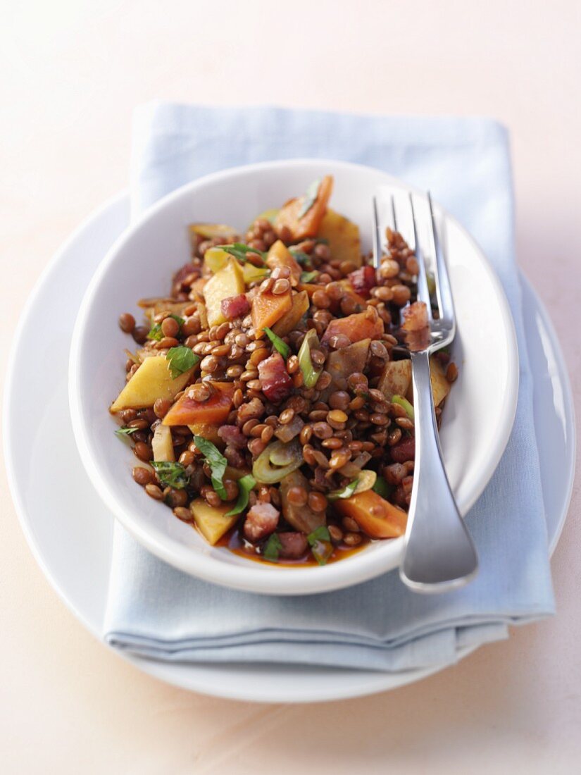 Lentil salad with bacon, carrots and potatoes