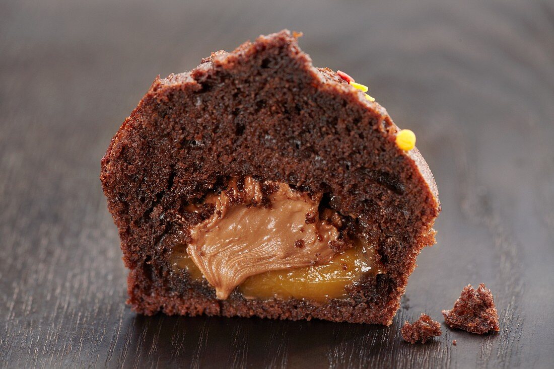 A chocolate muffin filled with orange and chocolate cream