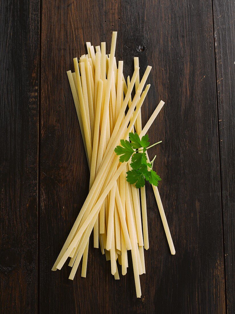 Tagliatelle on wooden background