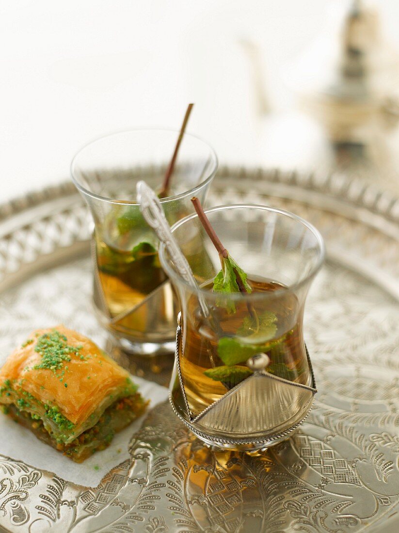 Baklava and mint tea on a silver tray