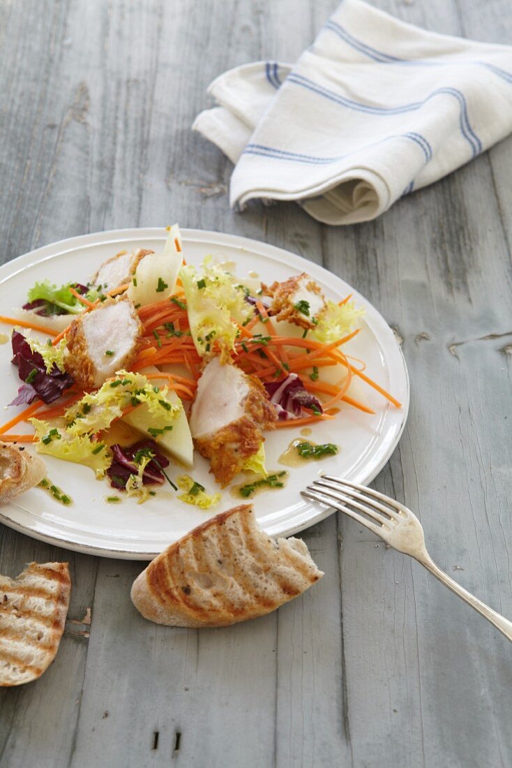 A spring salad with carrots and chicken