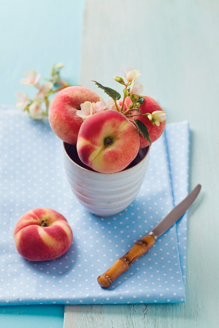 Pfirsiche in einer Schale mit Pfirsichblüten