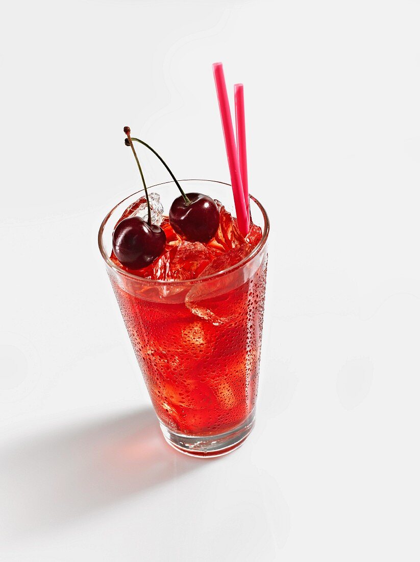 A glass of cherry tea with ice cubes