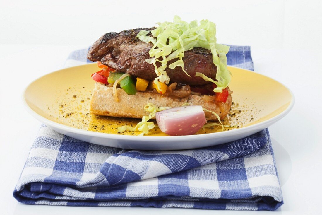 Ciabatta with beef steak and vegetables