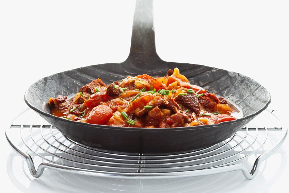 Pasta sauce in a pan on a circular grill rack