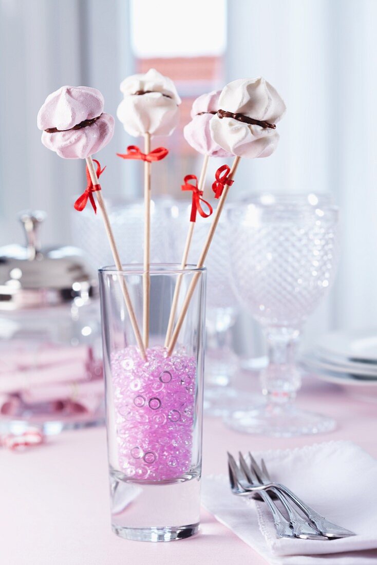 Meringue lollies as dessert and table decoration