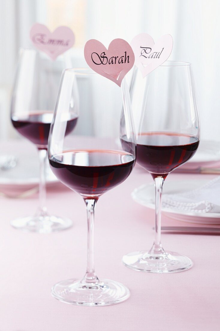 Glasses of red wine with heart-shaped name labels
