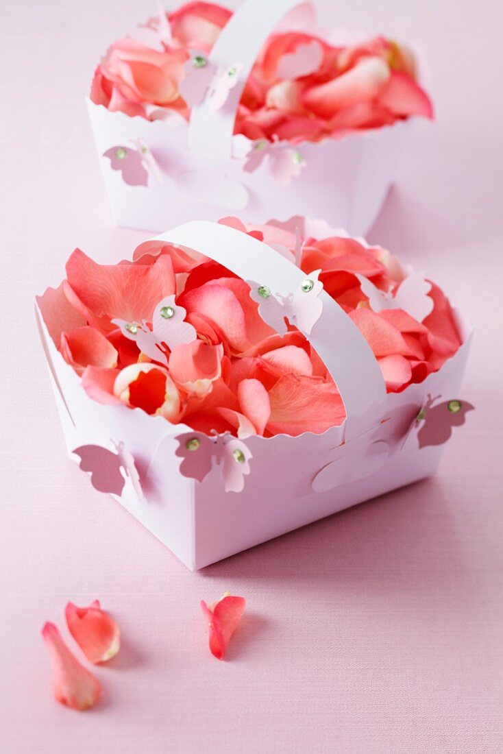 Punnets of rose petals with butterfly decorations