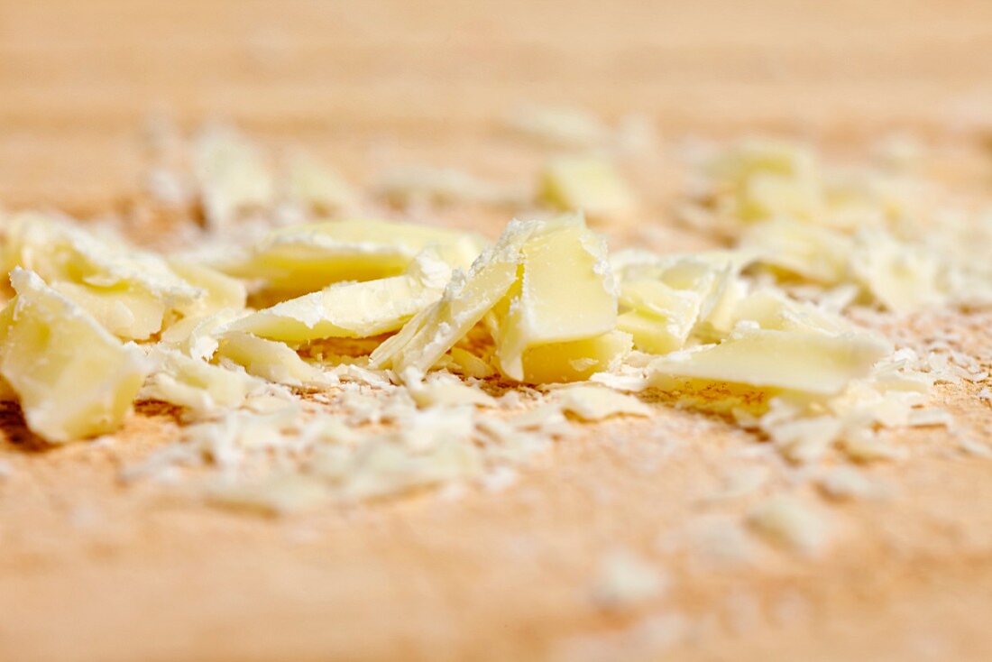 Splinters of white chocolate on a wooden board