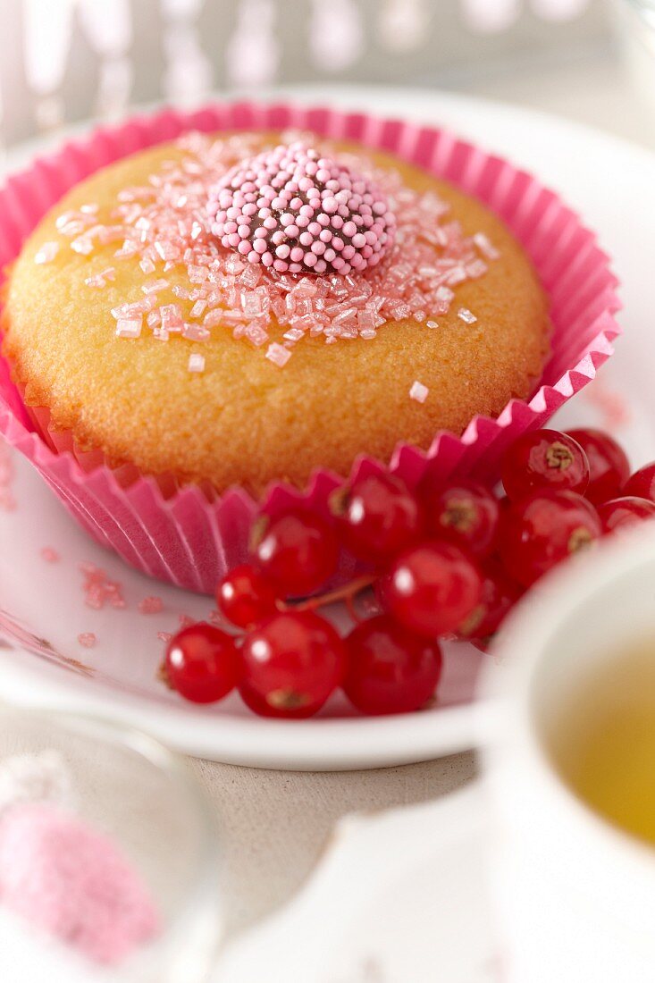 A cupcake with redcurrants
