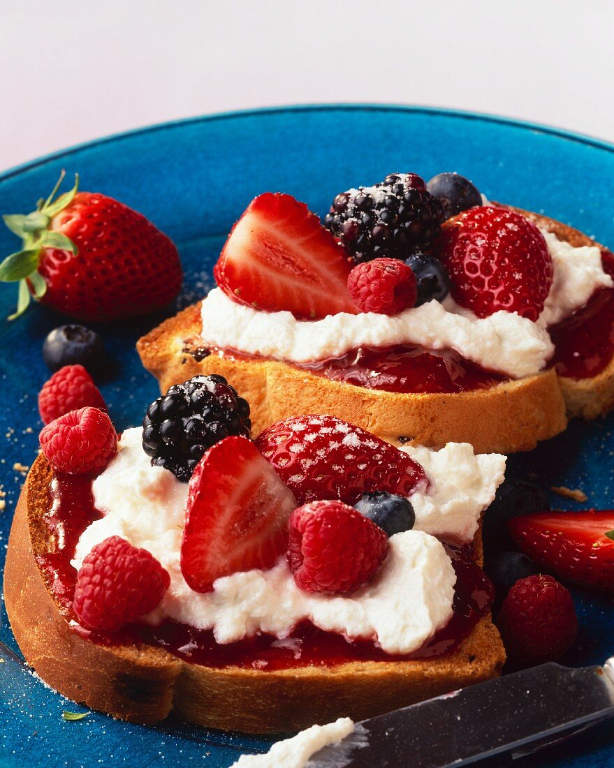 Brioche slices topped with cream cheese and berries