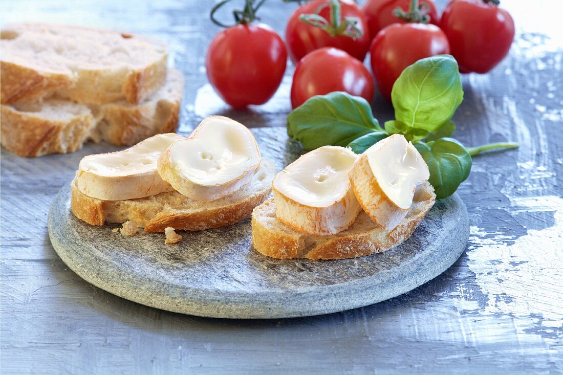 Baguette with soft cheese, basil and tomatoes