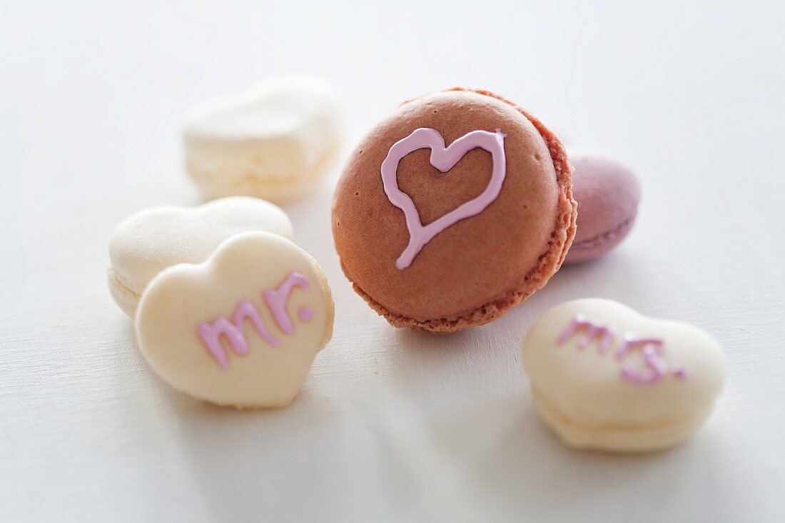 Macaroons decorated with hearts and writing using sugar icing
