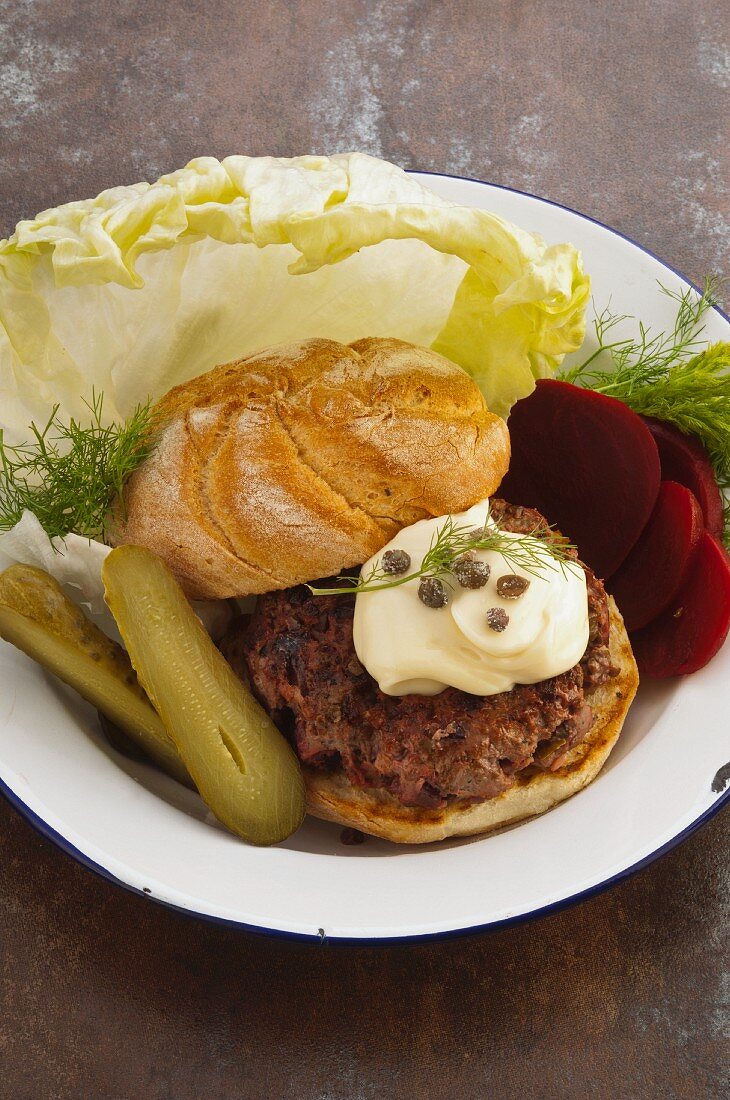 A burger with capers, pickled gherkins and beetroot (Sweden)