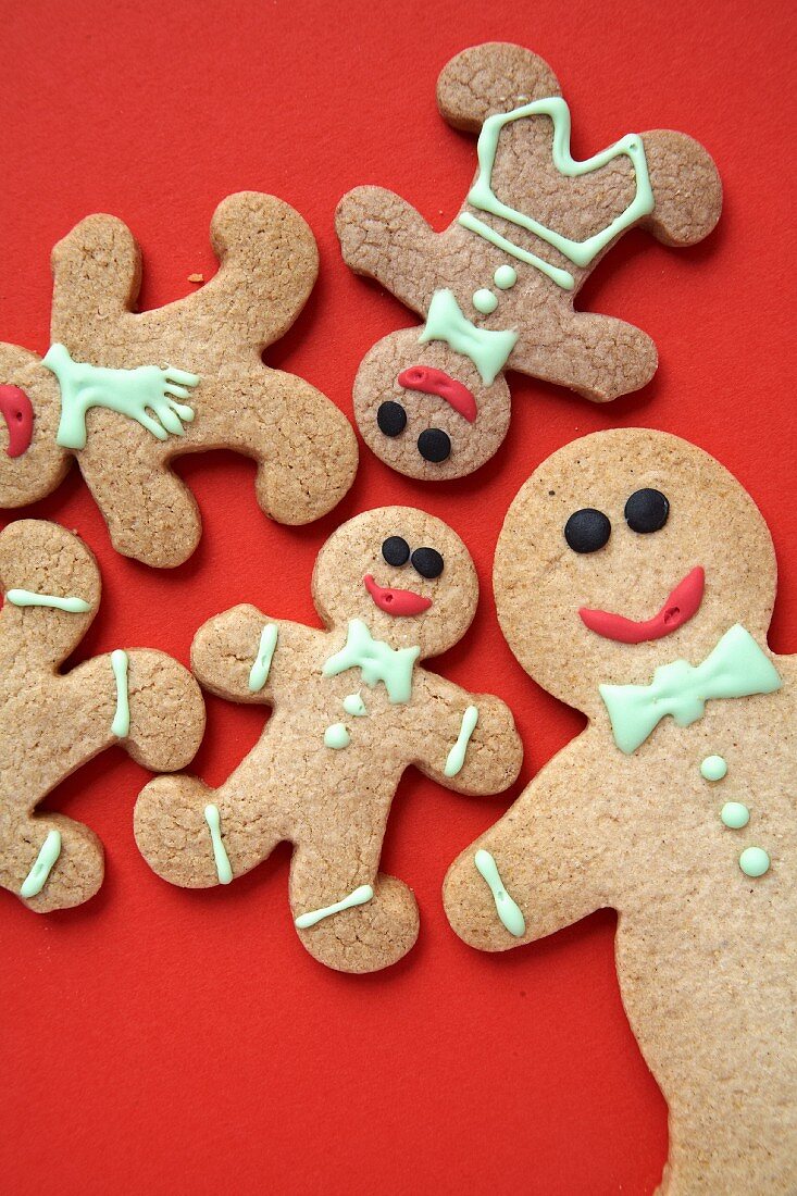 Gingerbread men on a red surface
