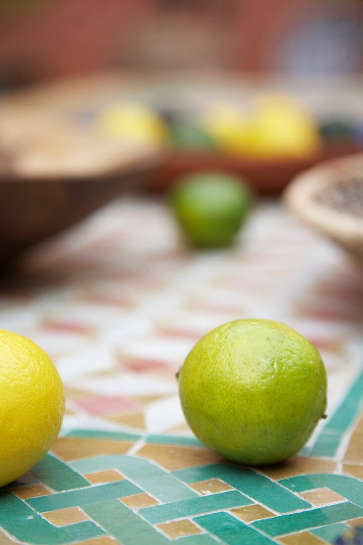 Lemons and limes on mosaic tiles