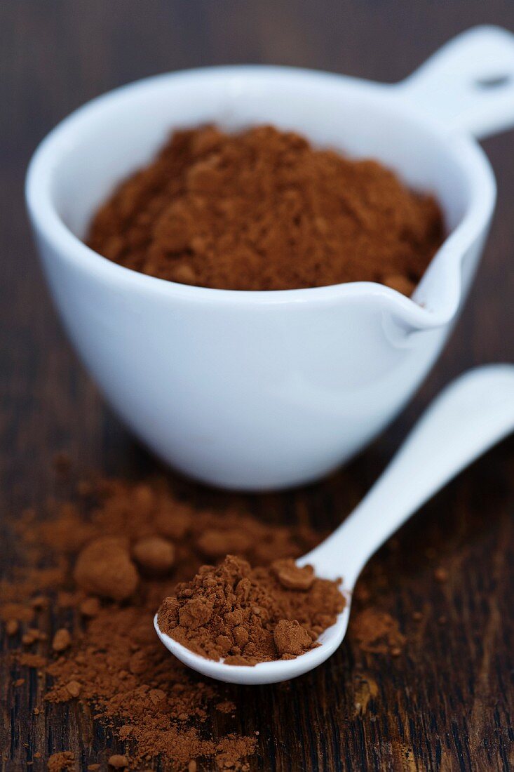 Cocoa powder in a small bowl and on a spoon