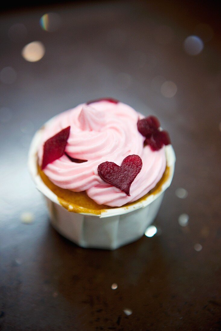 A cupcake topped with beetroot