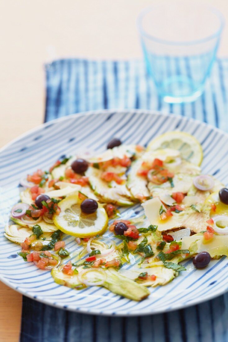 Artichoke carpaccio with olives and lemons