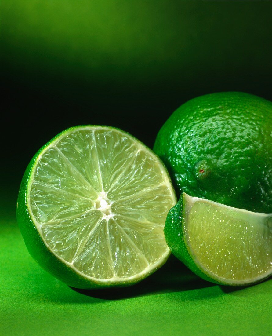 A lime, a lime half and a wedge of lime