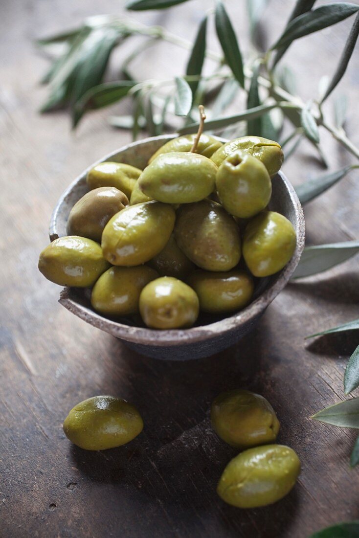 Green olives in a ceramic dish