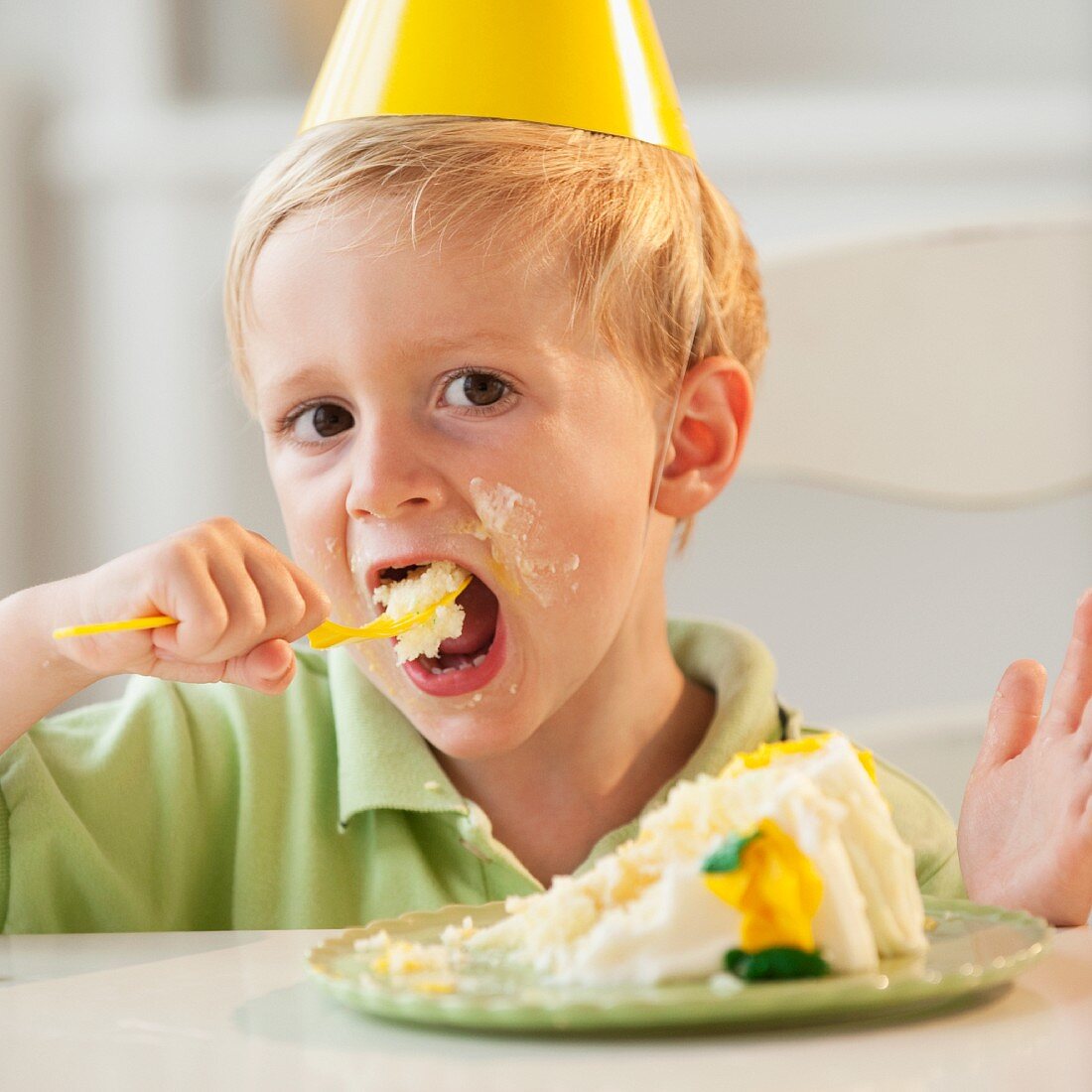 Young child eating birthday cake