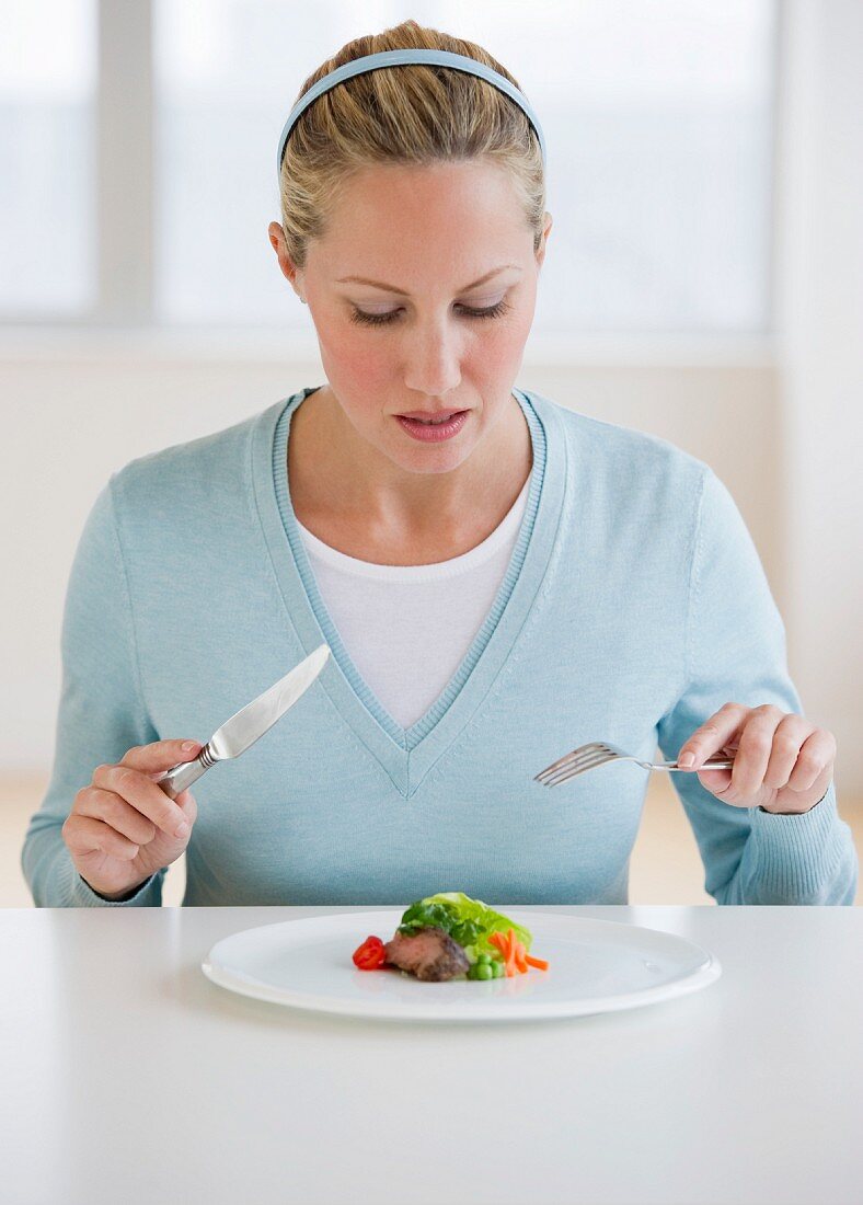 Woman eating small portion of food
