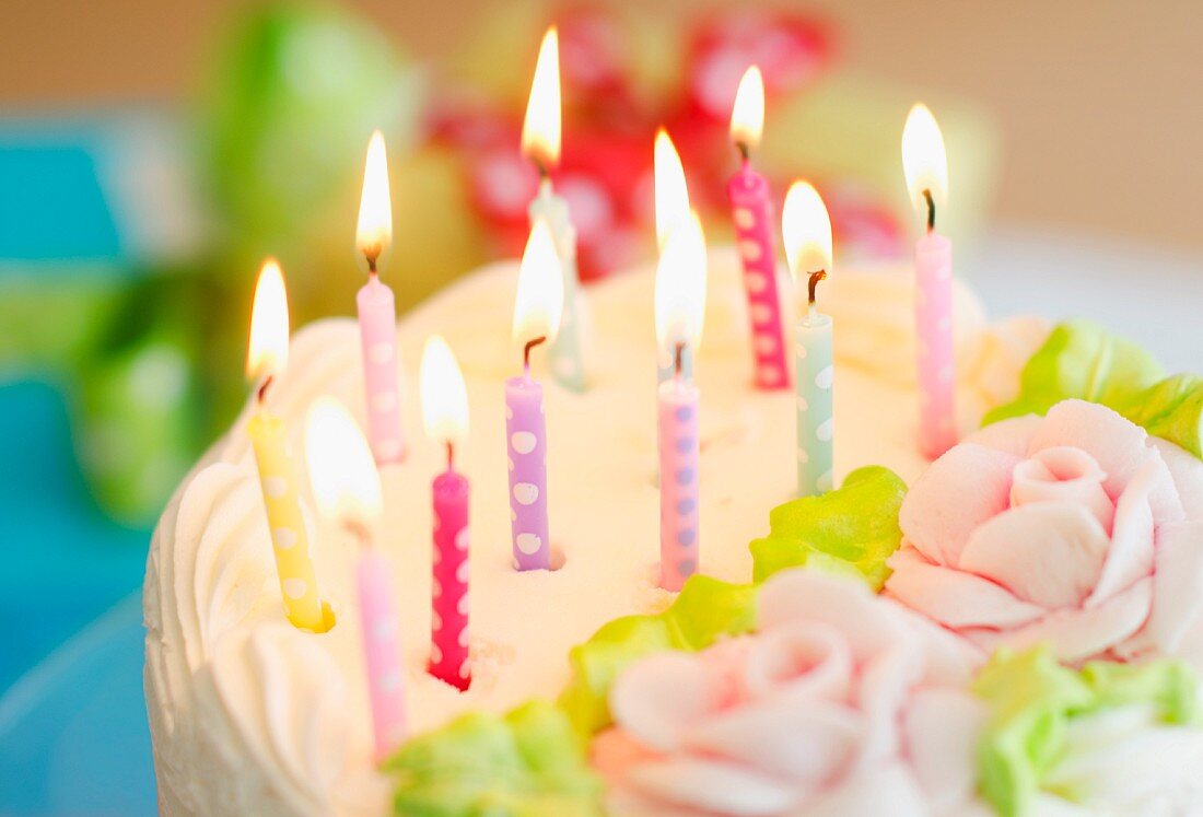 Illuminated candles on cake