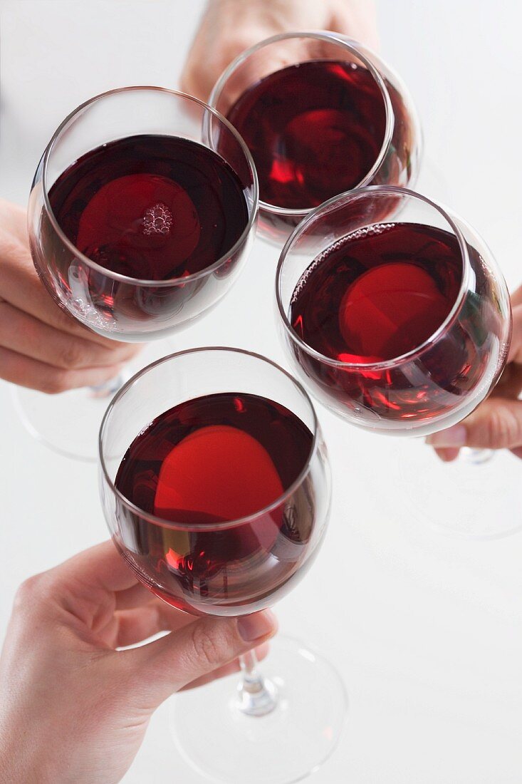 Closeup of hands toasting with wine