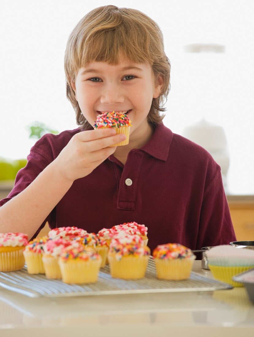 Boy eating home-made cupcake