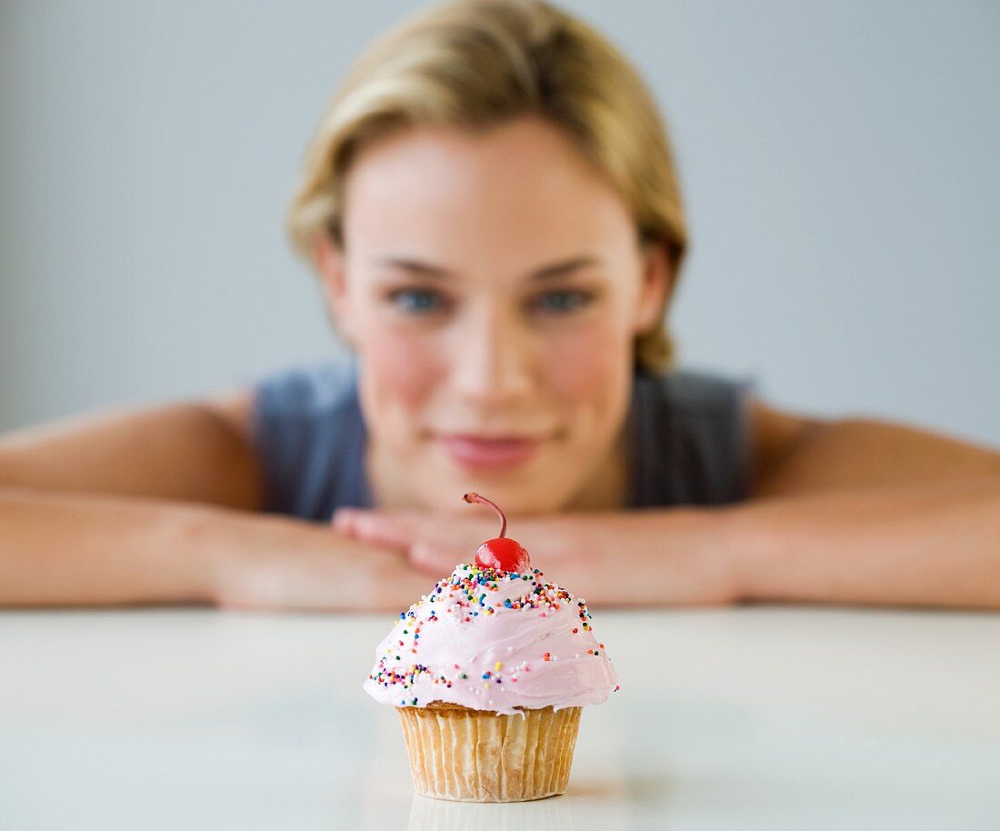 Woman looking at cupcake