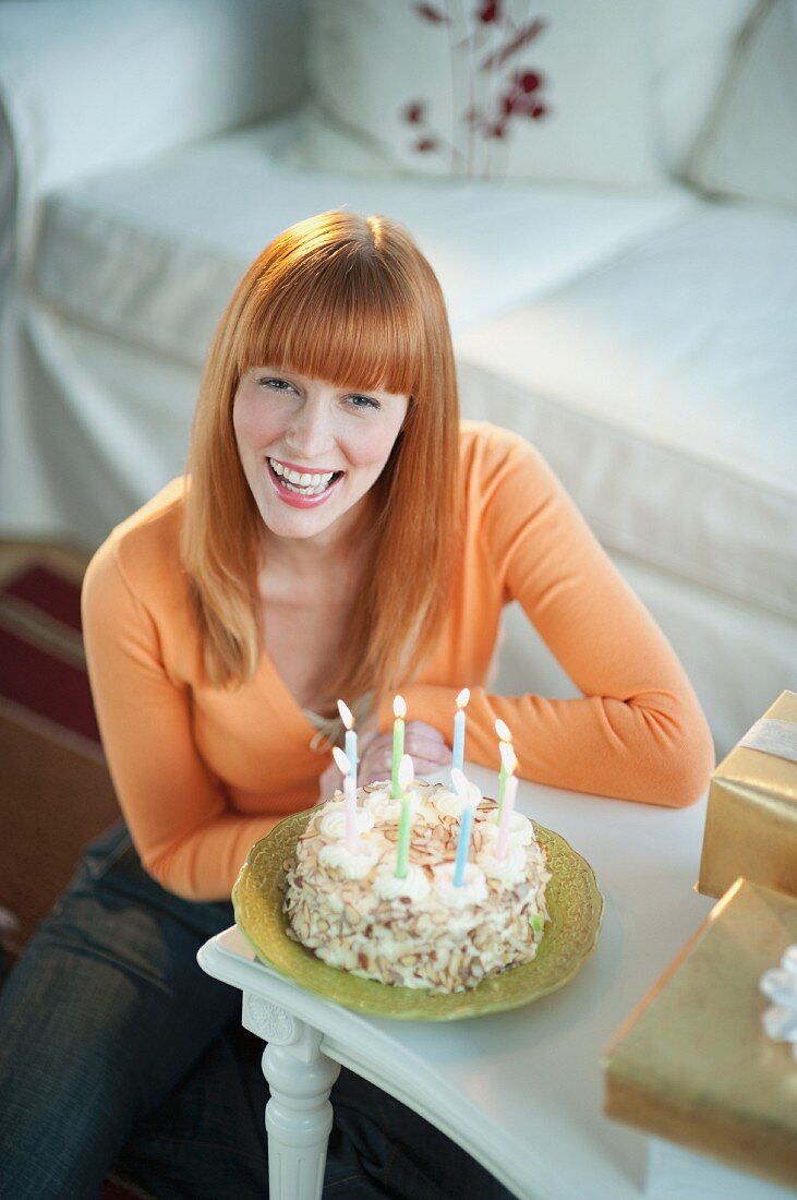 Frau feiert Geburtstag mit Kuchen