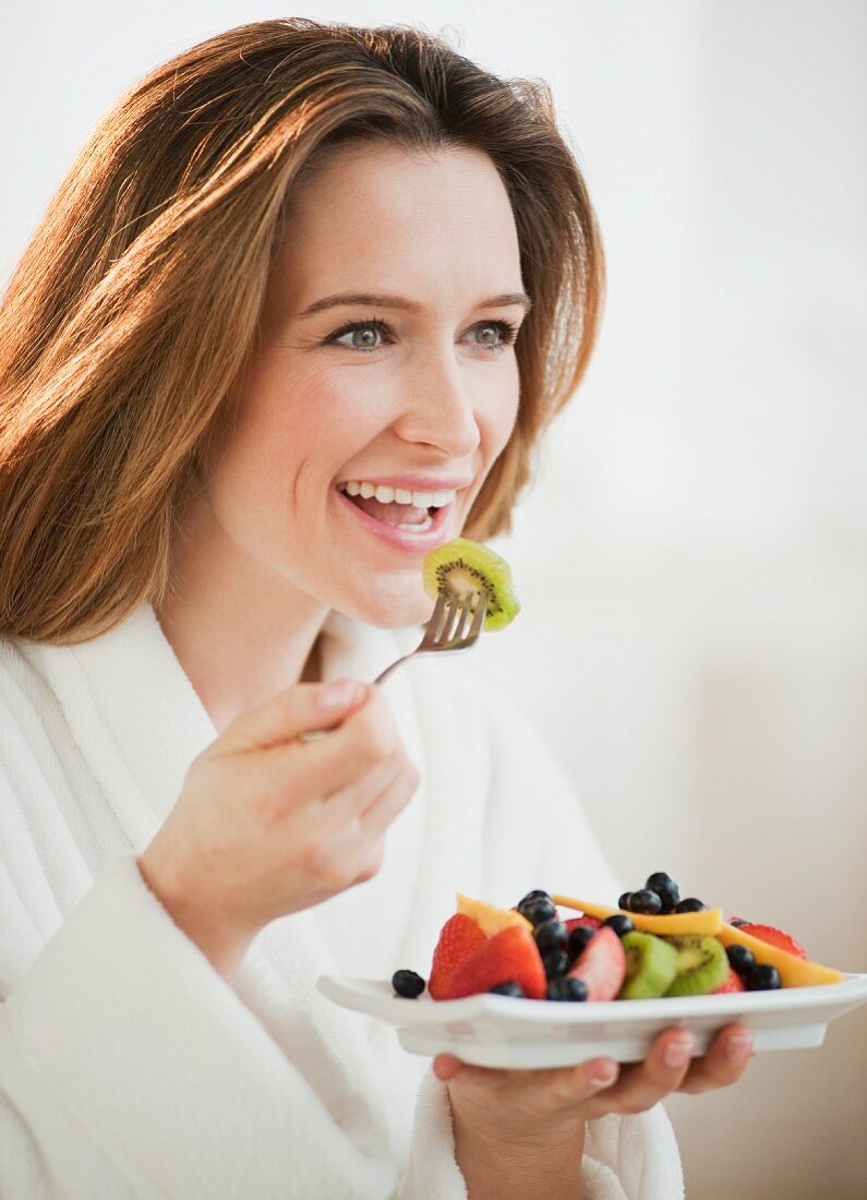 Woman eating fresh fruit